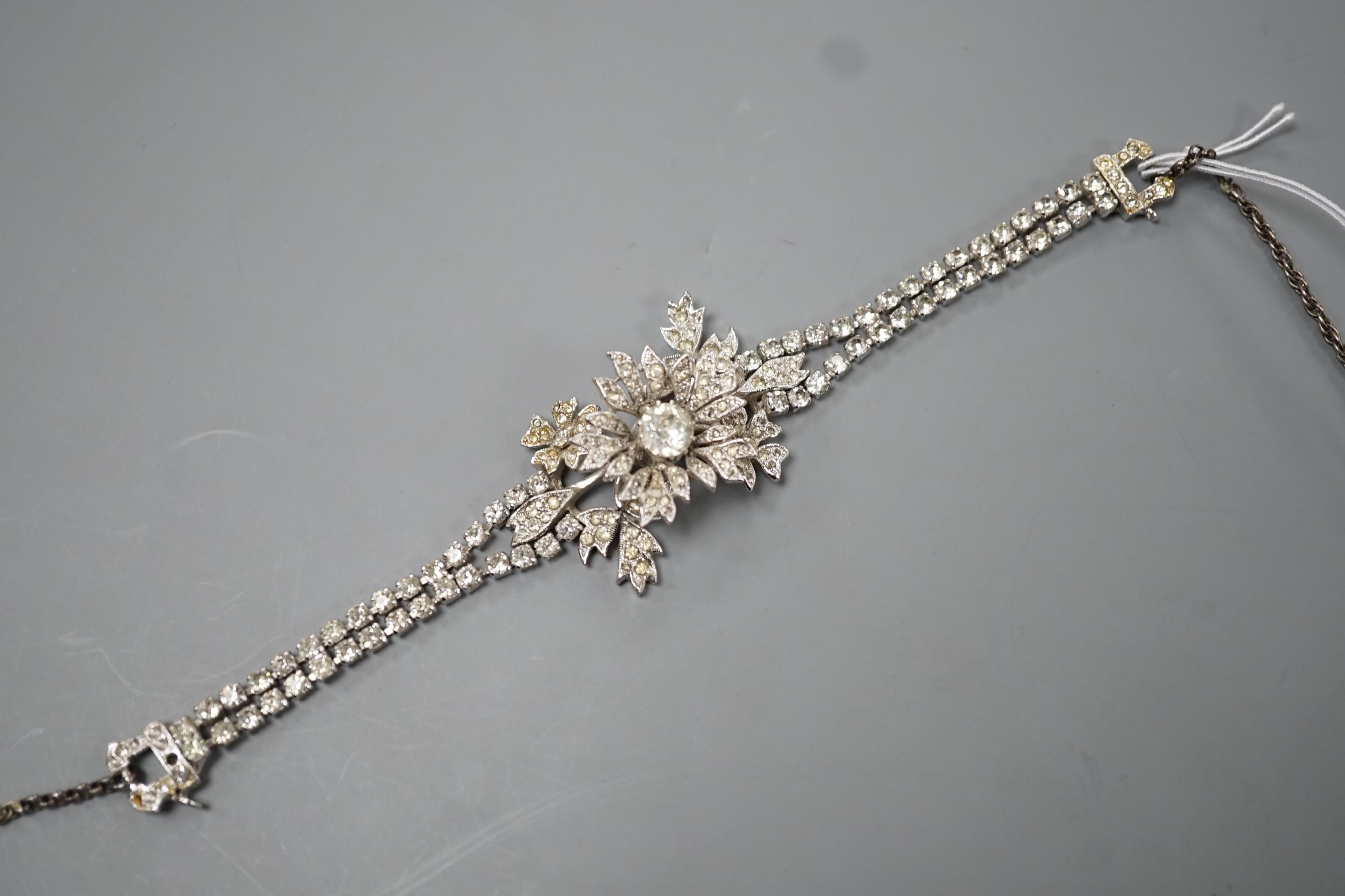 A Christian Dior paste cluster set bracelet, with central en tremblent floral motif, 19cm.